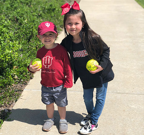 Picture of a kids from IU Women's Softball game.